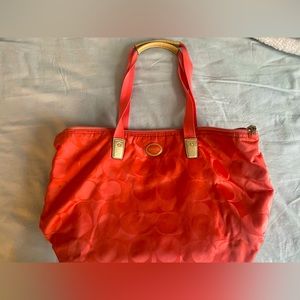 Salmon Coach overnight bag with clutch.
